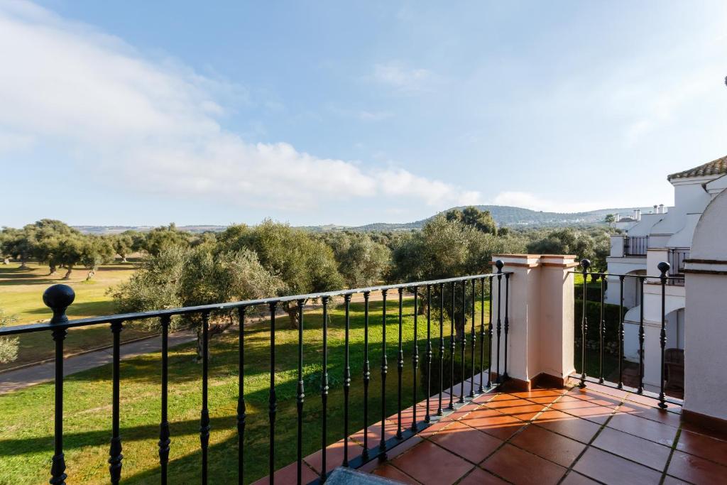 a balcony with a view of a green field at Arcos Gardens Sol Rent Golf in Arcos de la Frontera