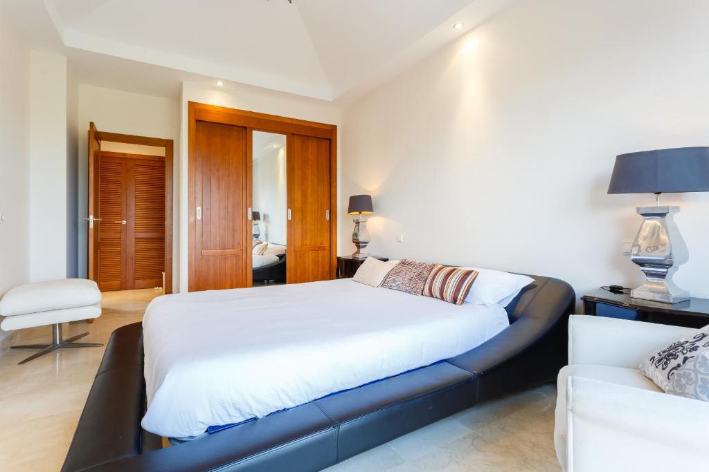 a bedroom with a large bed and a couch at Arcos Gardens Sol Rent Golf in Arcos de la Frontera
