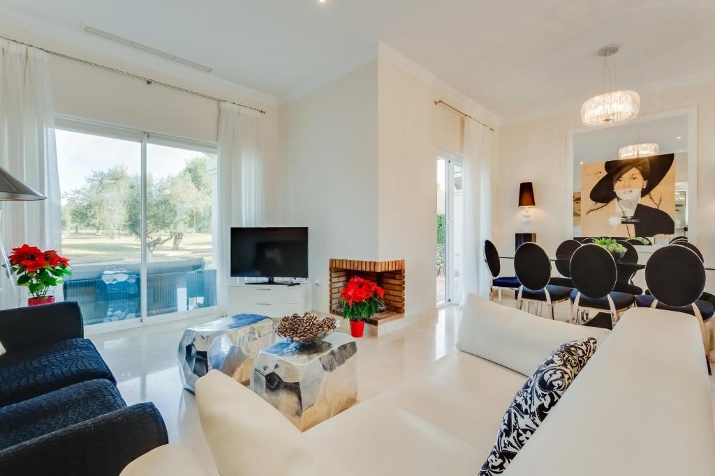 a living room with a couch and a tv at Arcos Gardens Sol Rent Golf in Arcos de la Frontera