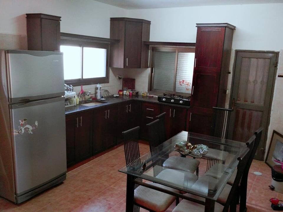 A kitchen or kitchenette at Aman Hostel