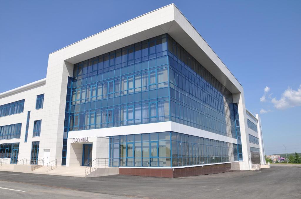 a large office building with glass windows at Azalya Hotel in Kazan
