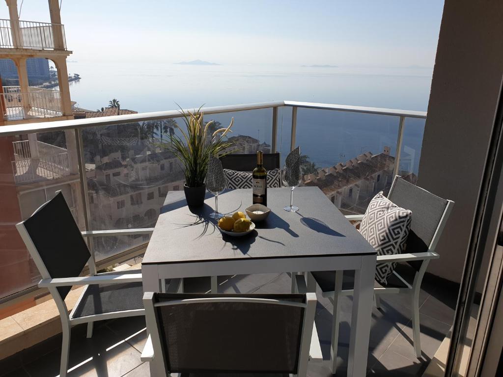 een tafel met een fles wijn op een balkon bij La Manga Paradies zwischen den zwei Meeren in La Manga del Mar Menor