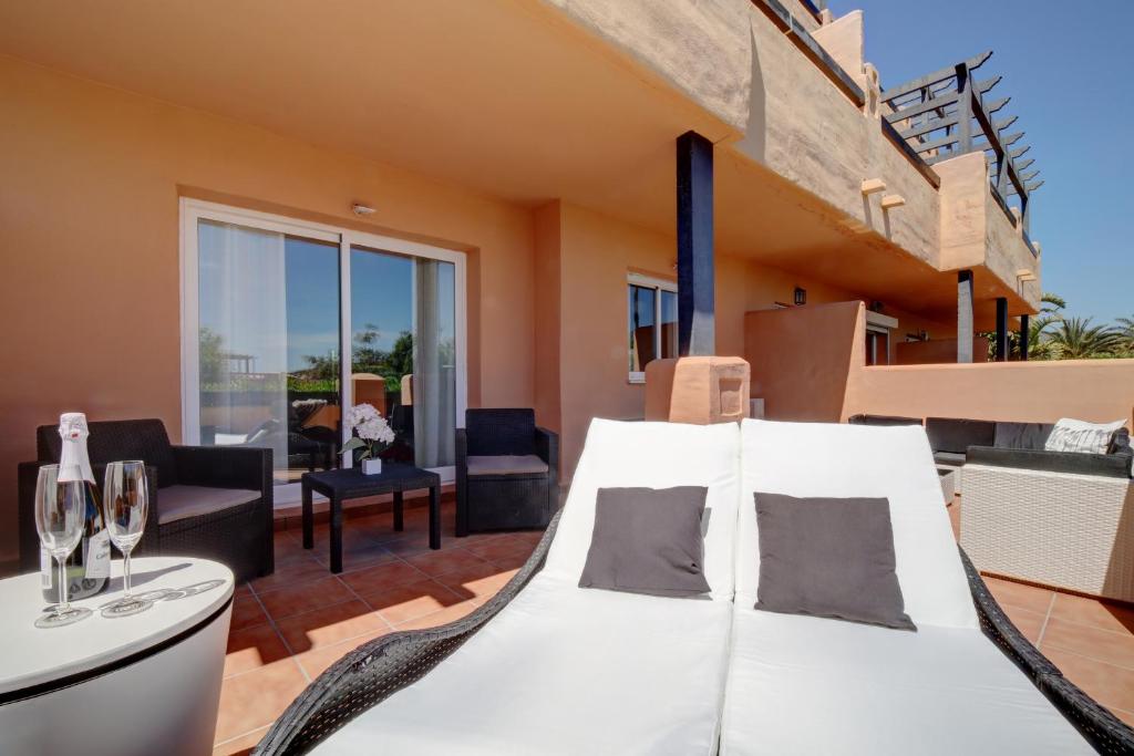 a bedroom with a bed and a living room at Casares del Sol Ground Floor Apartment in Casares