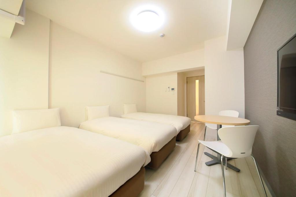 Postel nebo postele na pokoji v ubytování Bay Hotel Urayasu-ekimae
