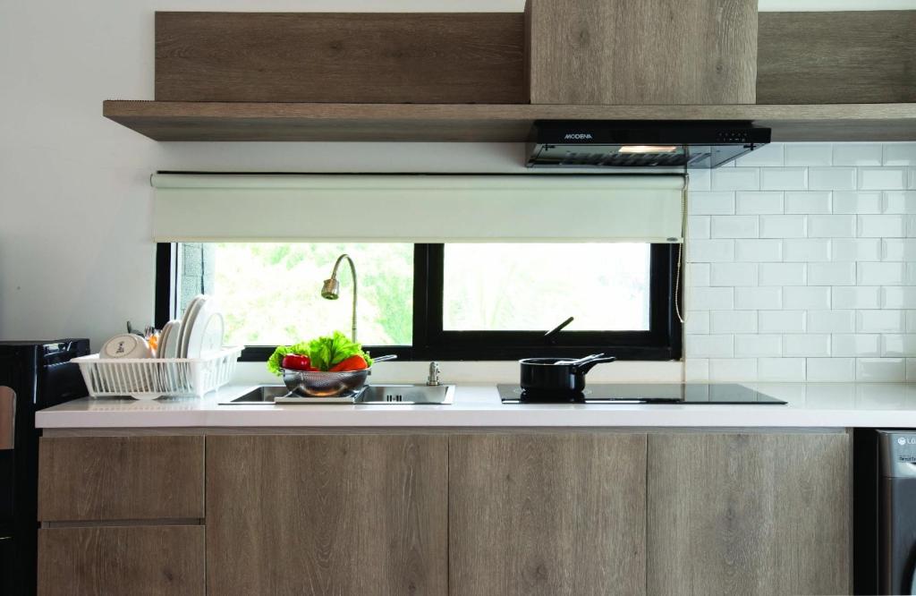 a kitchen counter with a sink and a window at Ariama Serviced Residence in Jakarta