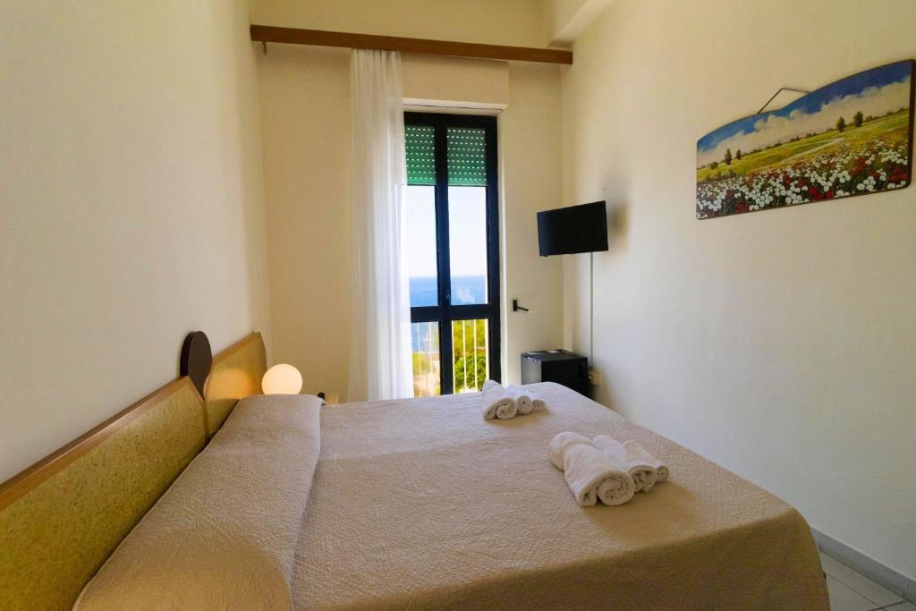 Postel nebo postele na pokoji v ubytování Albergo Palazzo