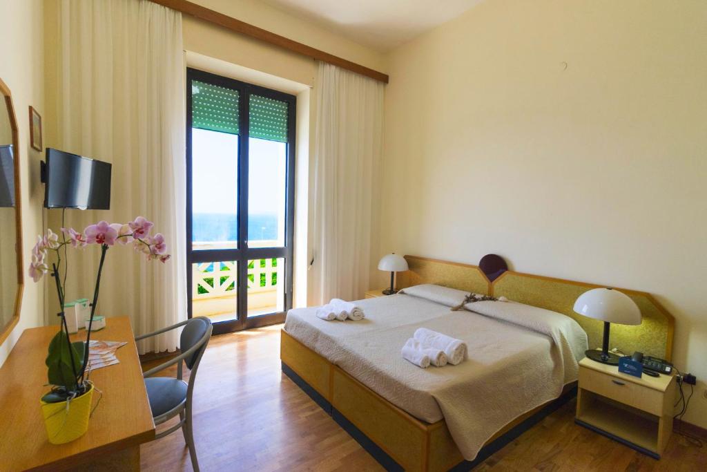 Postel nebo postele na pokoji v ubytování Albergo Palazzo