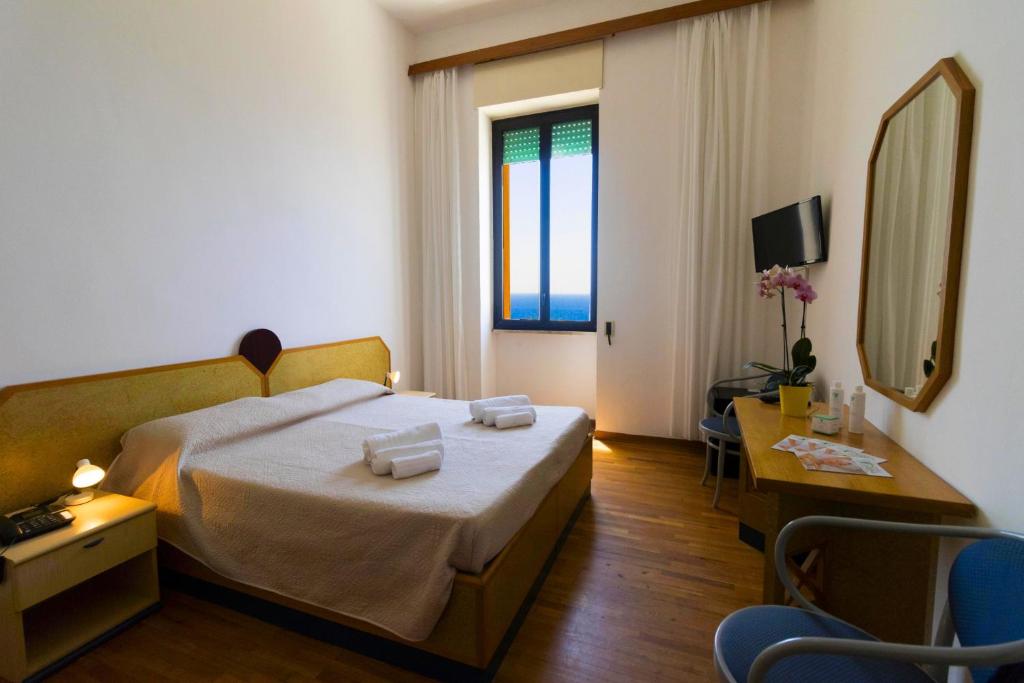 Postel nebo postele na pokoji v ubytování Albergo Palazzo