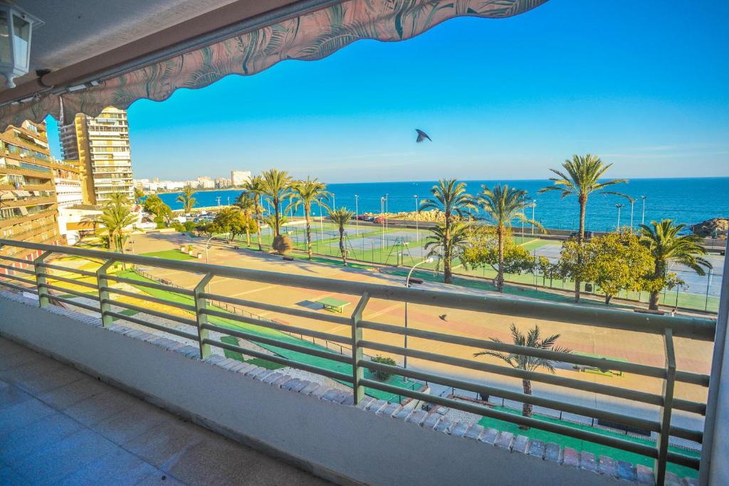 a balcony with a view of the beach and the ocean at Rocafel 5º in Alicante