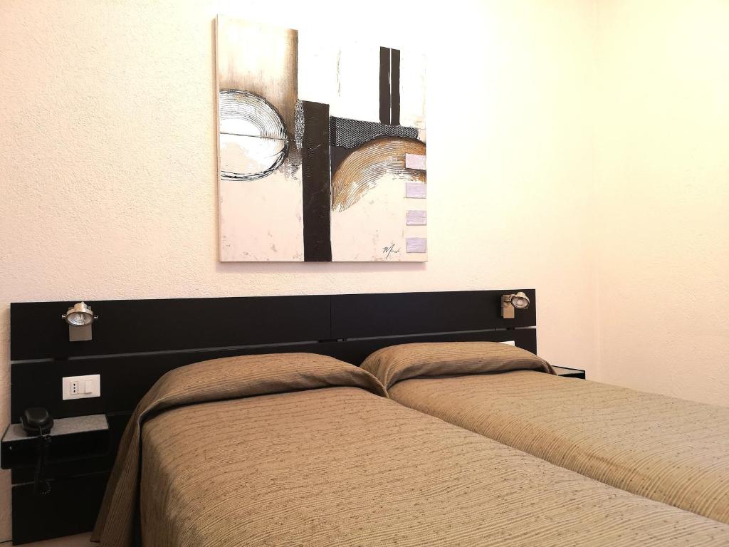Postel nebo postele na pokoji v ubytování Hotel Rossi