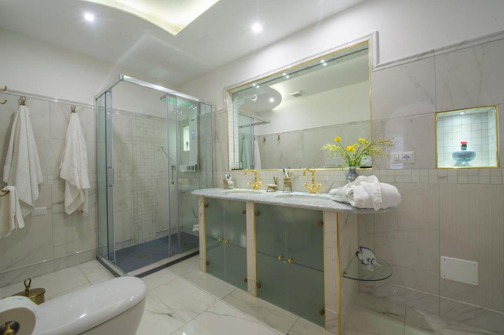 a bathroom with a sink and a shower and a toilet at Villa Briganti Seaview Terrace in Positano