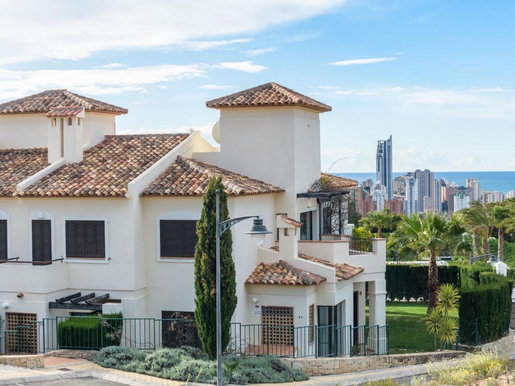 a white house with a view of the city at Belvilla by OYO Los Olivos in Benidorm