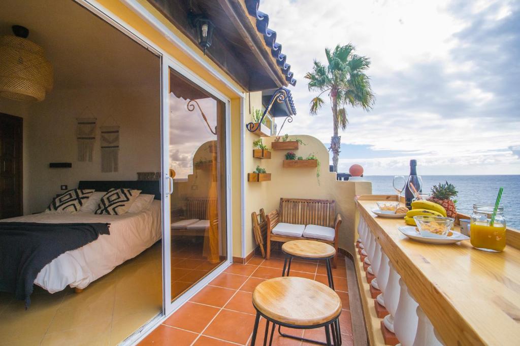 a room with a bed and a view of the ocean at Dream Bay Home in San Bartolomé