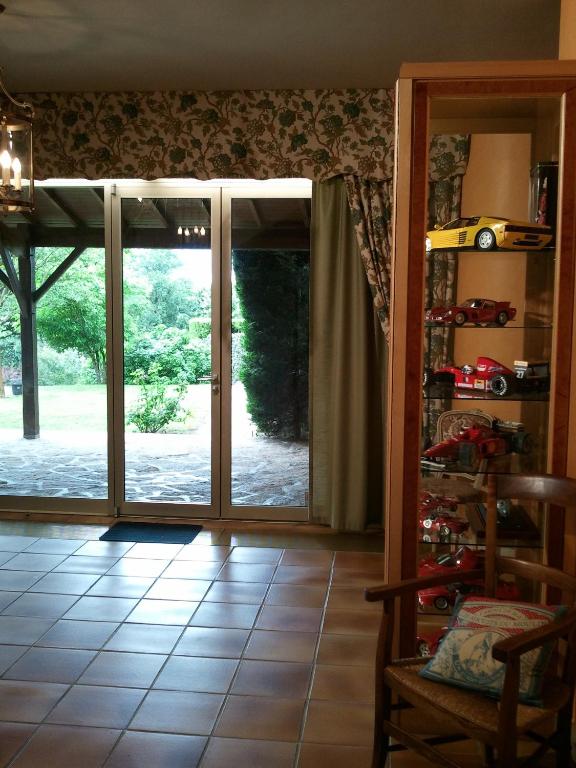an open sliding glass door with a view of a yard at Mas du Trezon in Cholet