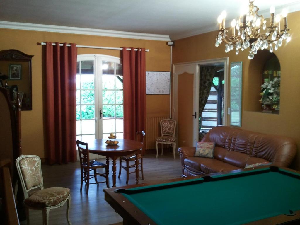 a living room with a pool table at Mas du Trezon in Cholet