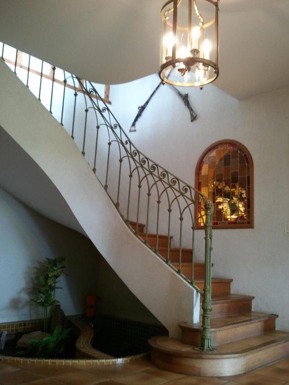 a staircase in a building with a chandelier at Mas du Trezon in Cholet