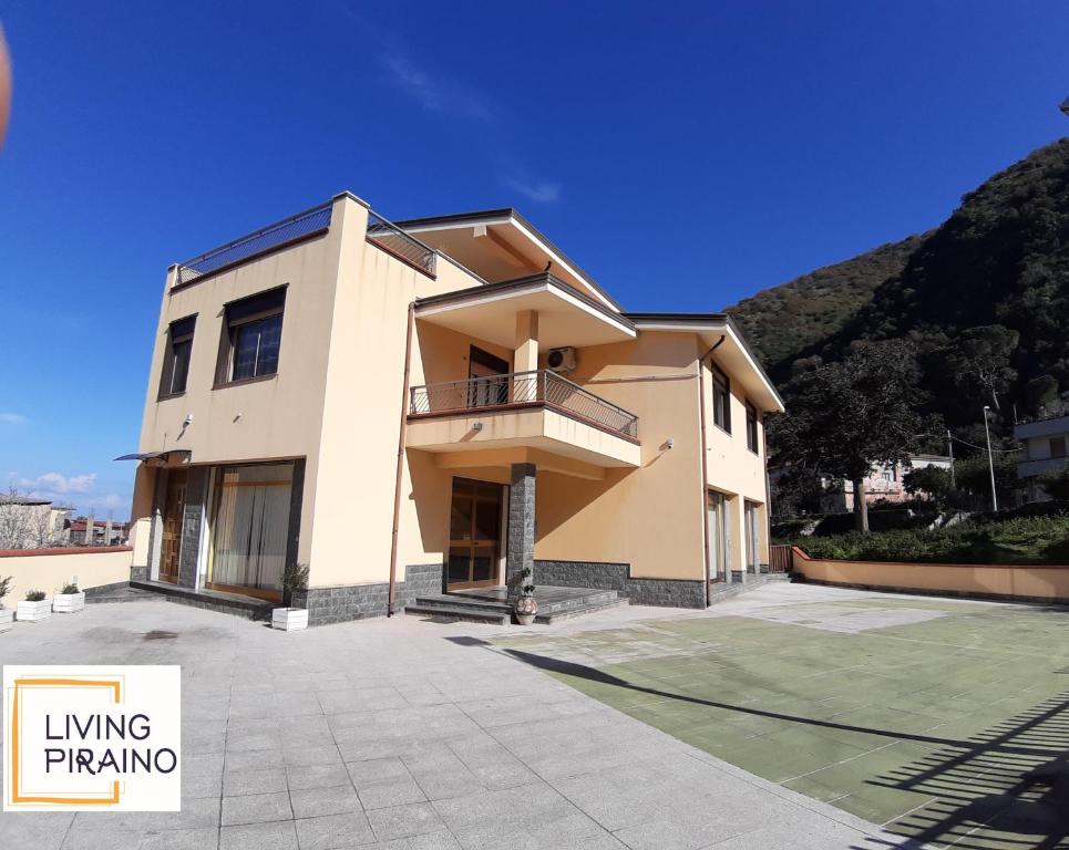 a large building with a balcony in front of it at Living Piraino casa vacanze in Piraino