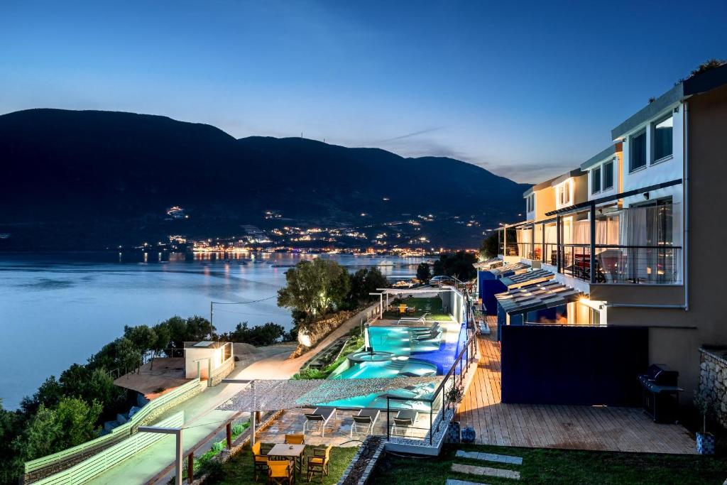 a hotel with a view of a river and a building at Sappho Boutique Suites in Vasiliki