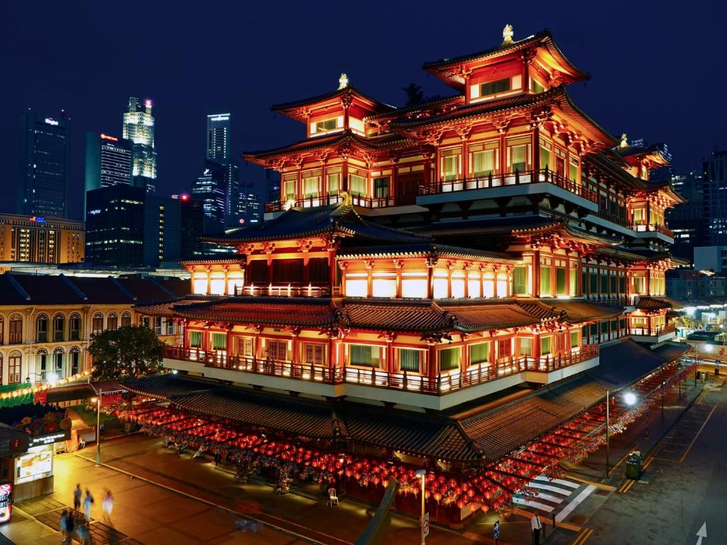 a chinese building with red lights at night at Wink at Mosque Street in Singapore