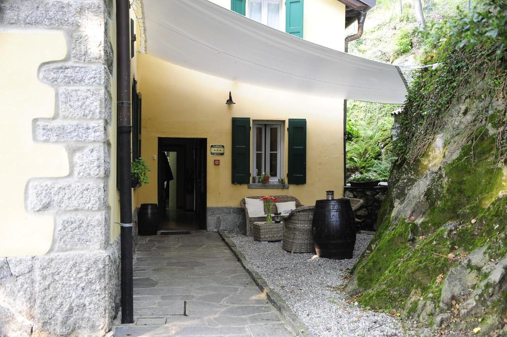 a doorway to a yellow house with a black door at Ristorante Hotel Falchetto in Brunate