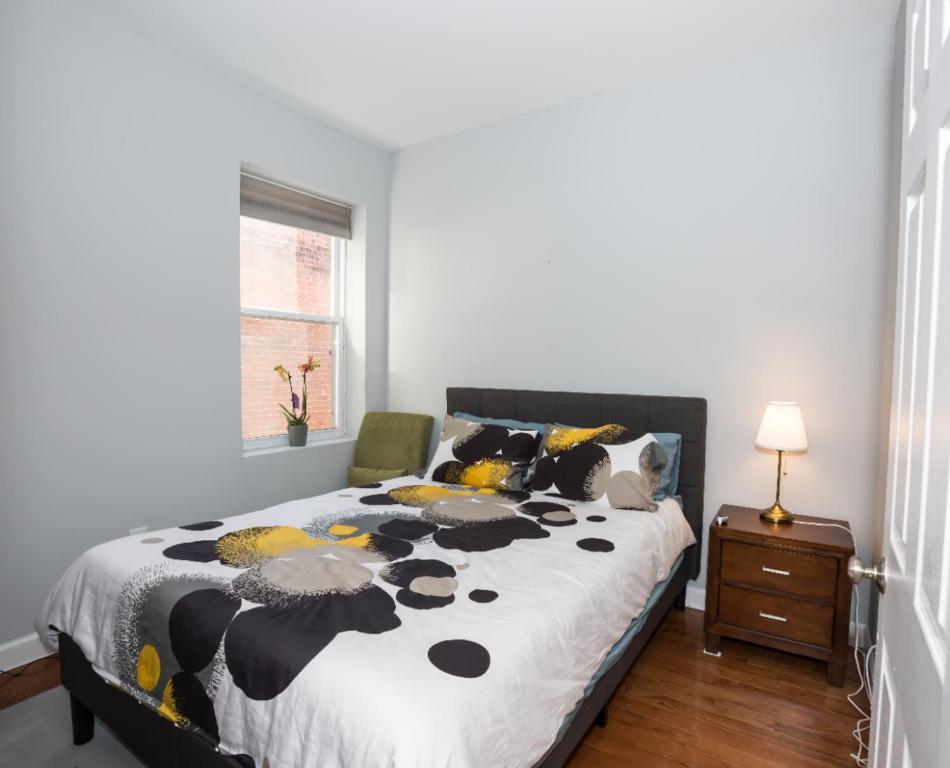 a bedroom with a bed with a black and yellow comforter at Steps to Convention Center, Downtown DC, and Metro Station: Private and Comfortable Bedroom/Bathroom in Washington