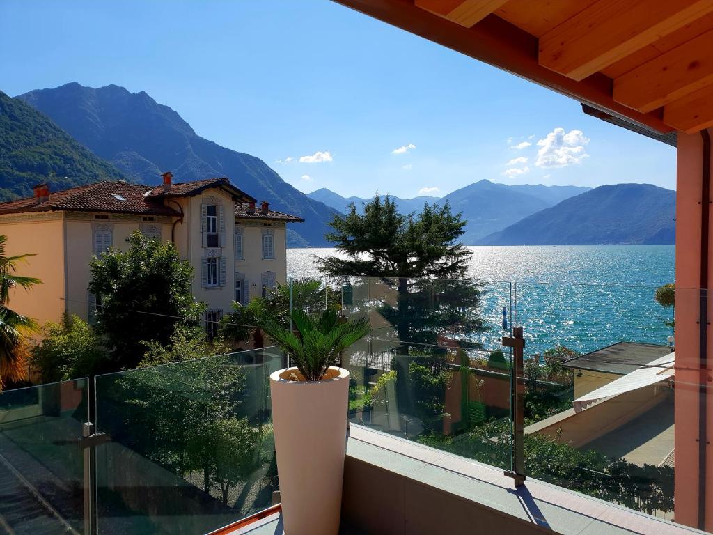 a balcony with a view of the water and mountains at Antica Dogana in Pisogne