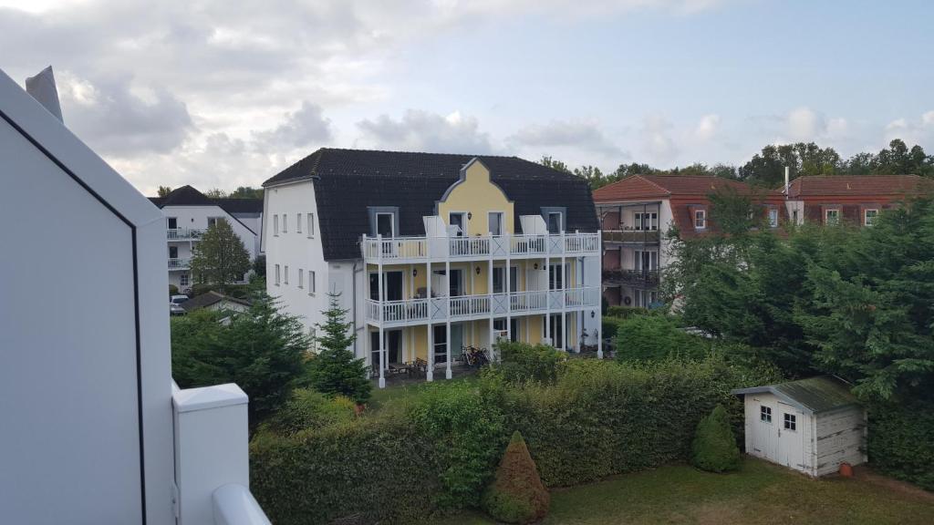 a large white building with a balcony in a city at 44 Kliffstraße in Nienhagen