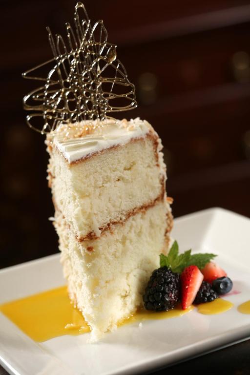 a piece of cake on a plate with strawberries at Marina Inn at Grande Dunes in Myrtle Beach