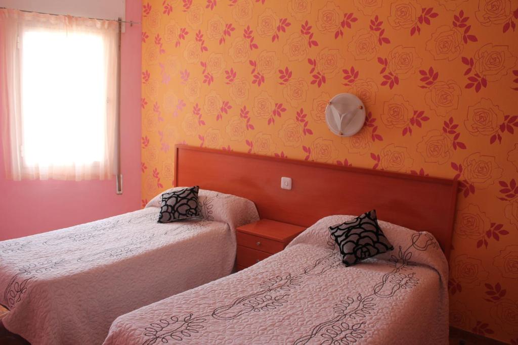 Postel nebo postele na pokoji v ubytování Hostal Julieta