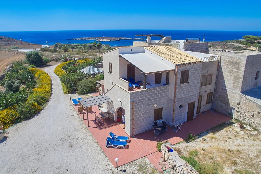 an aerial view of a house with the ocean in the background at Case Canino in Favignana