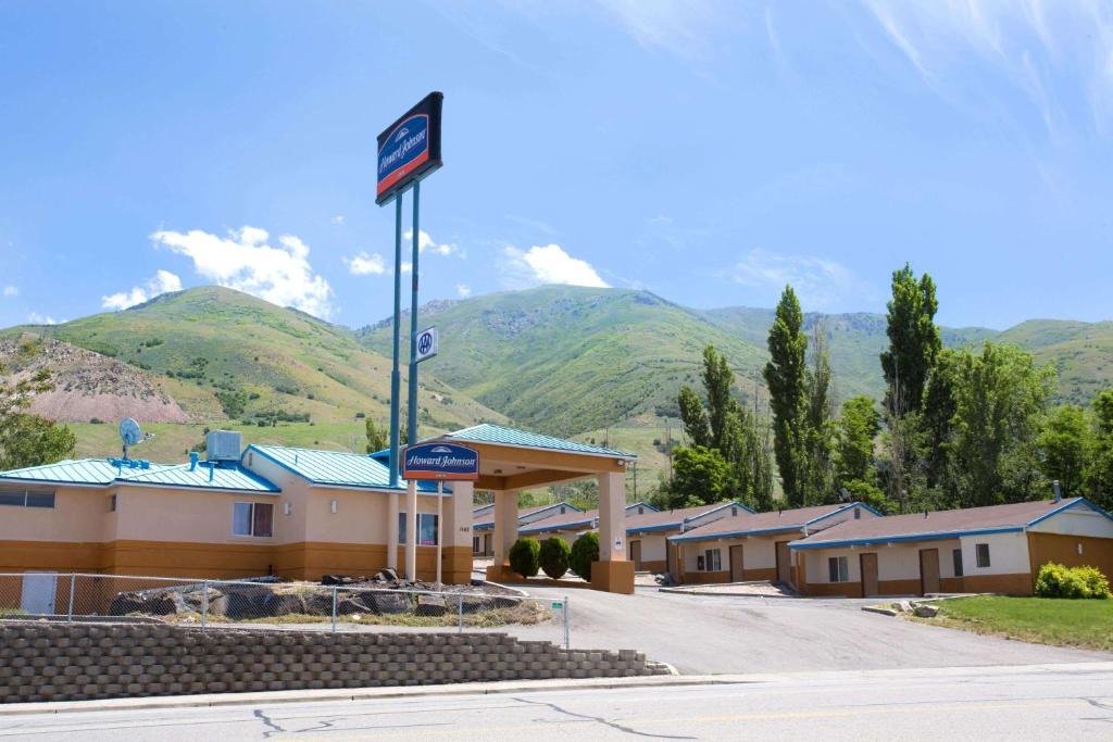a gas station with mountains in the background at Howard Johnson by Wyndham Brigham City in Brigham City