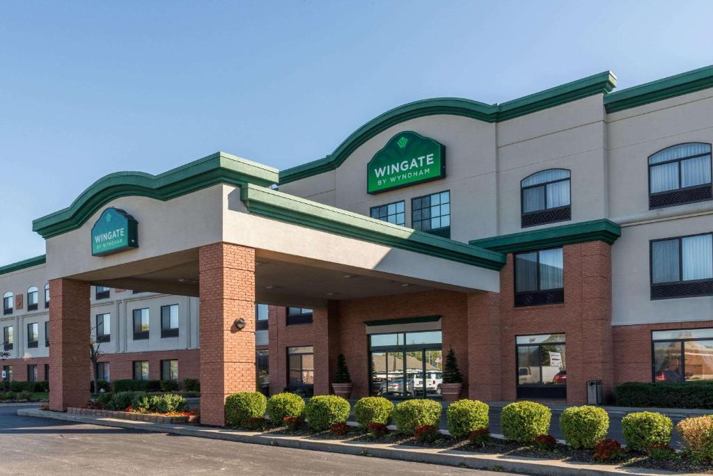 a hotel with a sign on the front of it at Wingate by Wyndham Airport - Rockville Road in Indianapolis