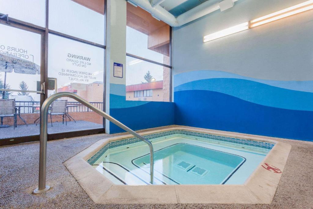 a jacuzzi tub in the corner of a building at Ramada by Wyndham Coquitlam in Coquitlam