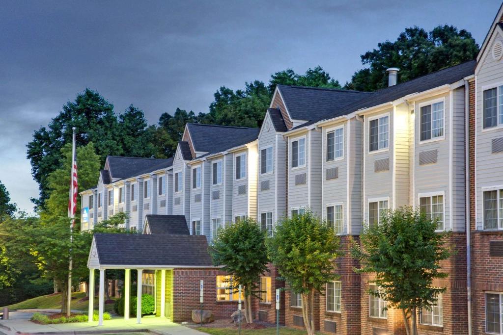 a rendering of the exterior of a building at Microtel Inn by Wyndham University Place in Charlotte