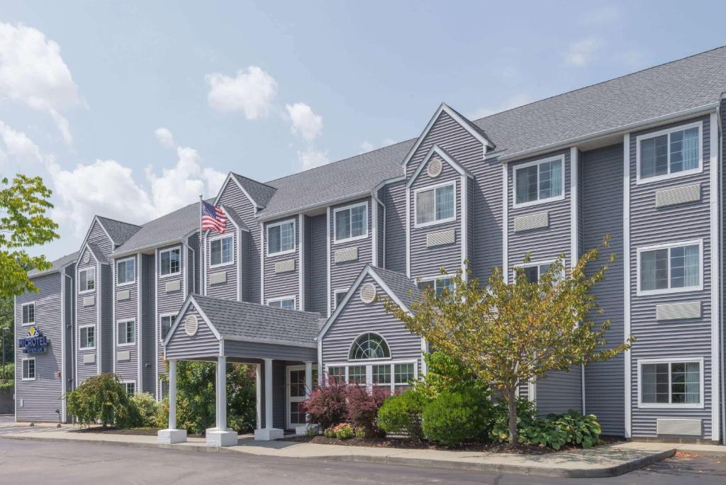 un gran edificio gris con bandera americana en Microtel Inn & Suites by Wyndham Uncasville Casino Area, en Uncasville
