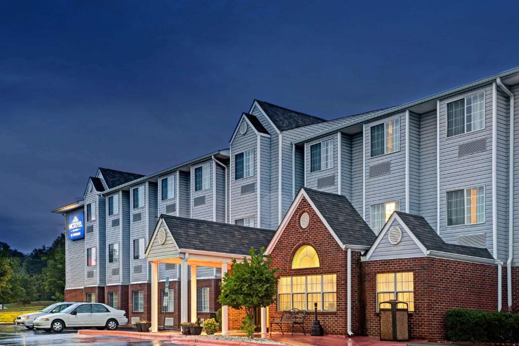 a building with a car parked in front of it at Microtel Inn & Suites by Wyndham Statesville in Statesville