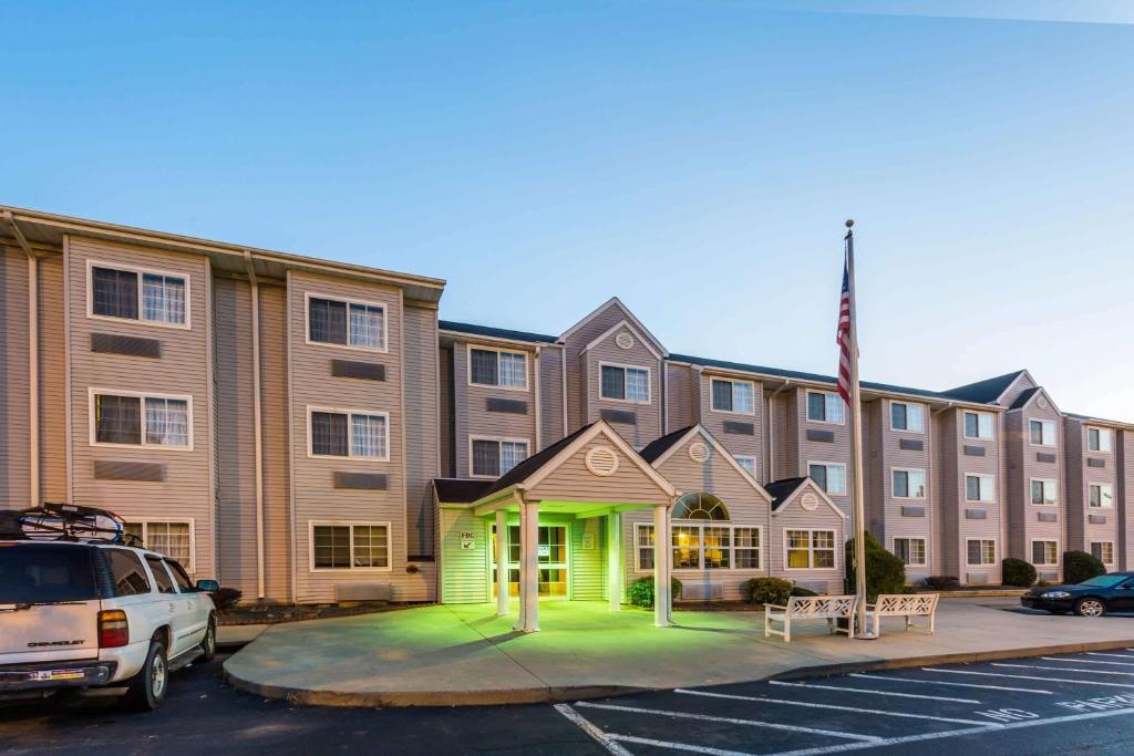 a large building with a green light in front of it at Microtel Inn & Suites by Wyndham Hillsborough in Hillsborough