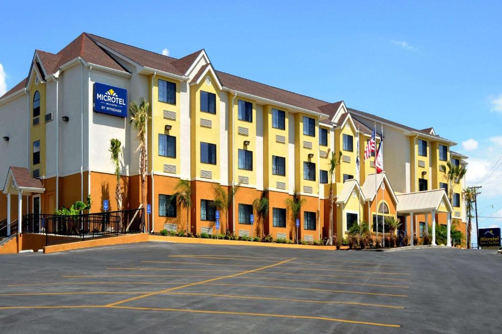 a large building with a large window on the side of the building at Microtel Inn & Suites by Wyndham New Braunfels I-35 in New Braunfels