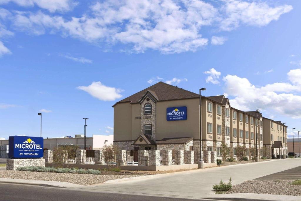 a rendering of the exterior of a building at Microtel Inn & Suites by Wyndham Odessa TX in Odessa