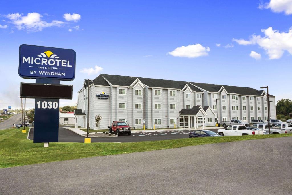 a hotel with a sign in front of a building at Microtel Inn and Suites Carrollton in Carrollton