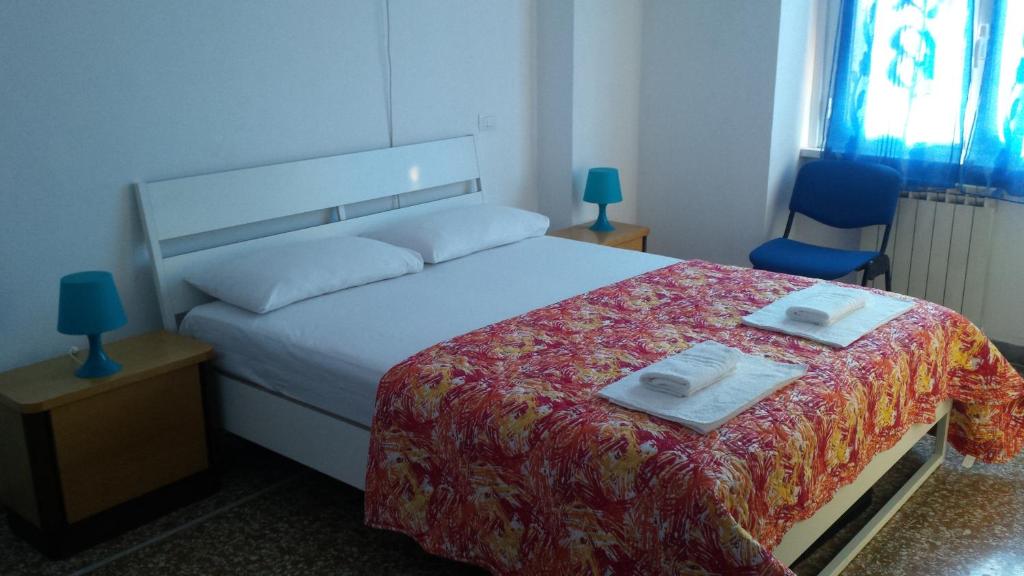 a bedroom with a bed with two towels on it at B&B Casa Felicità in Rome