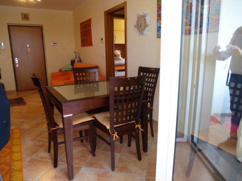 a dining room with a table and chairs and a living room at Appartamento Iolanda in Tortoreto Lido