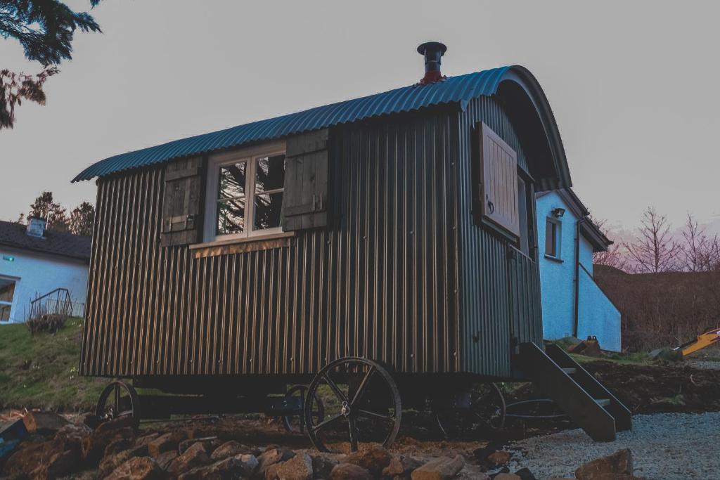 a tiny house sitting on top of a pile of rocks at Loch Eyre Shepherd Hut in Portree