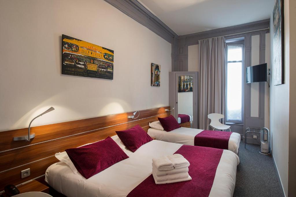 Postel nebo postele na pokoji v ubytování Hotel de Paris