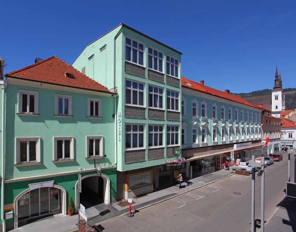 a row of colorful buildings on a street at Hotel Kindler 2,0 Self-Check-In in Leoben