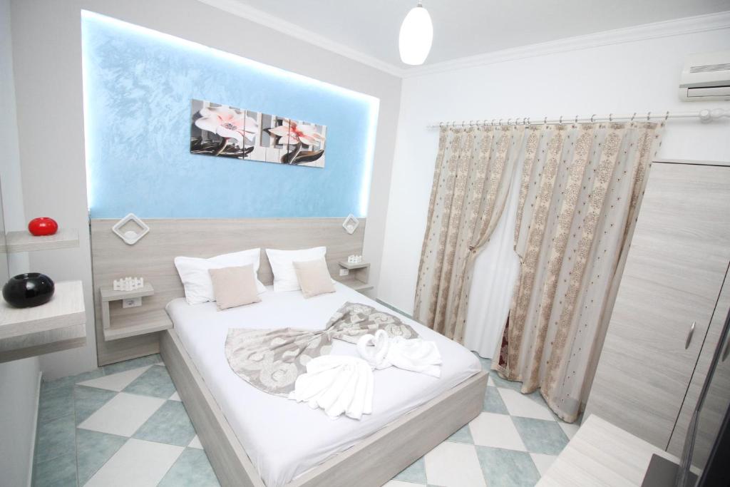Ένα ή περισσότερα κρεβάτια σε δωμάτιο στο Apartments Cota Guesthouse