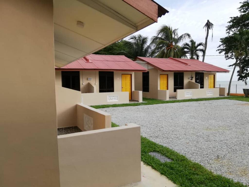 a row of houses with red roofs at Mutiara Chalet in Melaka