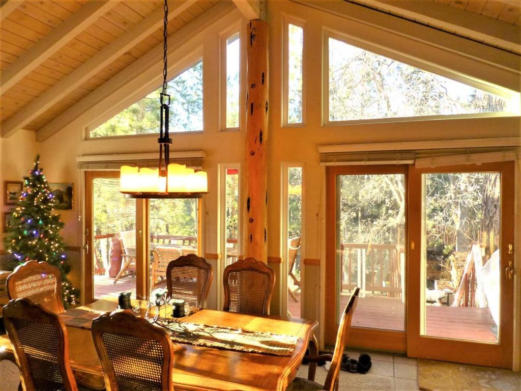 a dining room with a table and a christmas tree at Dream Getaway with Secluded Spa in Big Bear Lake