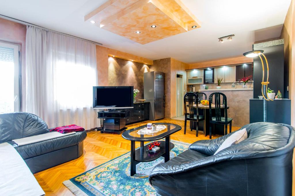 a living room with a couch and a table at Apartment City center in Novi Sad