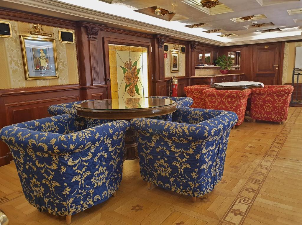 a room with blue chairs and a table andools at Royal San Marco Hotel in Venice